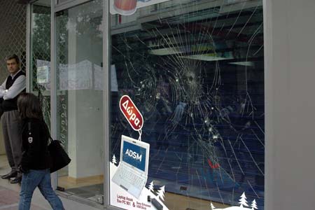 Photo taken on Dec. 12, 2008 shows the broken window after a protest march in Athens, capital of Greece. Riot police on Friday clashed with youths on the seventh day of Athens riots triggered by the death of the 15-year-old boy last Saturday. (Xinhua/Yang Shaobo)