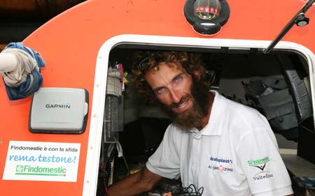 Italian adventurer Alex Bellini poses inside his row boat after arriving in the port city of Newcastle, about 120 km (75 miles) north-east of Sydney, in this handout picture December 13, 2008.