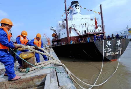 A cargo vessel leaves for Mawei port of southeast China's Taiwan, from Fuzhou, capital of southeast China's Fujian Province, Dec. 15, 2008. The Chinese mainland and Taiwan started direct air and sea transport and postal services Monday morning. 