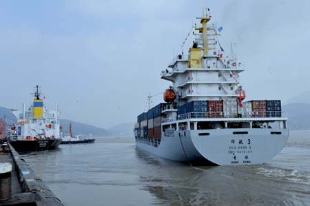 A cargo vessel leaves for Keelung Port in southeast China's Taiwan, from Mawei port in Fuzhou, capital of southeast China's Fujian Province, Dec. 15, 2008. The Chinese mainland and Taiwan started direct air and sea transport and postal services Monday morning. 