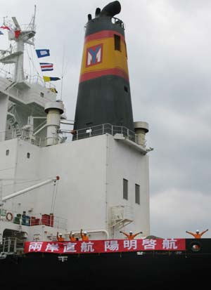 Working staff on a freight ship of Yang Ming Marine Transport Corp wave at a ceremony marking the start of direct sea transport between the Chinese mainland and Taiwan at Keelung Harbor of southeast China's Taiwan, Dec. 15, 2008. The Chinese mainland and Taiwan started direct air and sea transport and postal service Monday morning. 