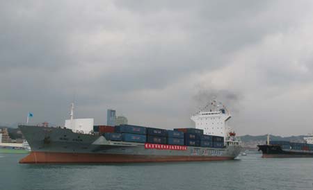 Freight ships are seen at a ceremony marking the start of direct sea transport between the Chinese mainland and Taiwan at Keelung Harbor of southeast China's Taiwan, Dec. 15, 2008. 