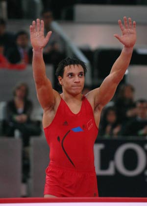 France's Thomas Bouhail waves to the audience after winning the competition during the men's vault final at the 14th Artistic Gymnastics World Cup in Madrid, capital of Spain, on Dec. 14, 2008. Bouhail claimed the title of the event with a result of 16.225 points. 