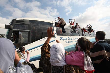 Buses carrying released Palestinian prisoners get through Beitunya checkpoint near Ramallah, Dec. 15, 2008.