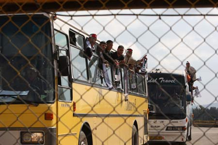 Buses carrying released Palestinian prisoners get through Beitunya checkpoint near Ramallah, Dec. 15, 2008. Israel released 224 Palestinians held in its prisons on Monday, nearly a week later than planned, in a move it described as a goodwill gesture to Palestinian President Mahmoud Abbas.
