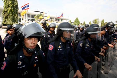 Riot police stand guard outside the parliment building in Bangkok, capital of Thailand, Dec. 15, 2008.