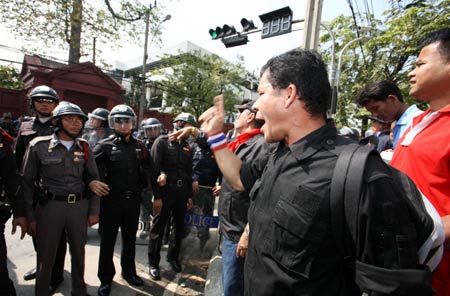  A protestor confronts with riot police outside the parliment building in Bangkok, capital of Thailand, Dec. 15, 2008. 