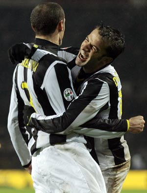 Juventus striker Alessandro Del Piero, center, followed by teammate Giorgio  Chiellini, left, with other teammates, warms-up next to an Italian Serie B  second division sign, at bottom, before the start of the