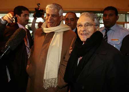 OPEC Secretary-General Abdullah al-Badri (2nd L) and Algeria's Oil Minister and OPEC President Chakib Khelil smile on their arrival in the western Algerian city of Oran December 15, 2008. 