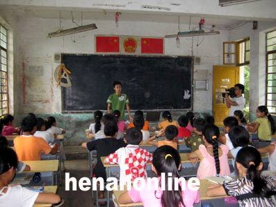 A college student teaches at a class in rural Henan Province as part of a program to aid education in poor countryside.