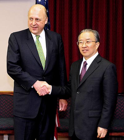 Chinese State Councilor Dai Bingguo (R) shakes hands with U.S. Deputy Secretary of State John Negroponte in Washington Dec. 15, 2008. Dai Bingguo and John Negroponte co-chaired the sixth China-U.S. Strategic Dialogue in Washington on Monday. 