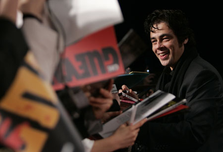 Cast member Benicio Del Toro signs autographs for fans on the red carpet at the Japan premiere of the film 