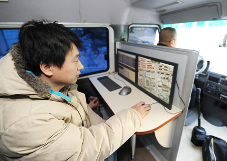 A technician demonstrates how the multi-functional road detector car works on Dec. 11, 2008.