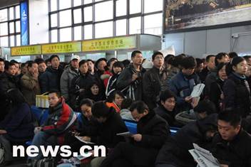 Passengers queuing to check tickets in Beijing West Railway Station on December 11, 2008.