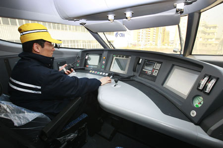 A driver tests the power system of a new CRH sleeper train in Shanghai on Tuesday, December 16, 2008. 