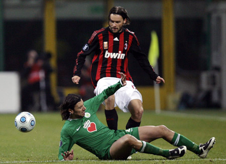 AC Milan's Marek Jankulovski (top) fights for the ball with Wolfsburg's Cristian Zaccardo during their UEFA Cup soccer match at the San Siro stadium in Milan Dec. 17, 2008. 