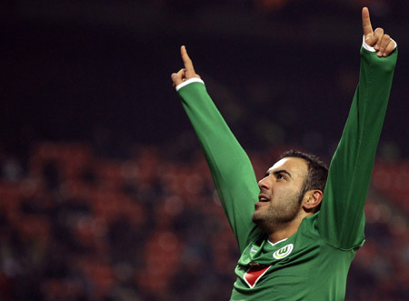 Wolfsburg's Mahir Saglik celebrates after scoring a second goal against AC Milan during their UEFA Cup soccer match at the San Siro stadium in Milan December 17, 2008.