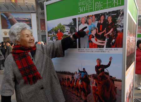 Chen Shihe points herself in a picture at an exhibition featuring China's 30 years' reform and opening-up at Wangfujing Street in Beijing, China, on Dec. 16, 2008. 