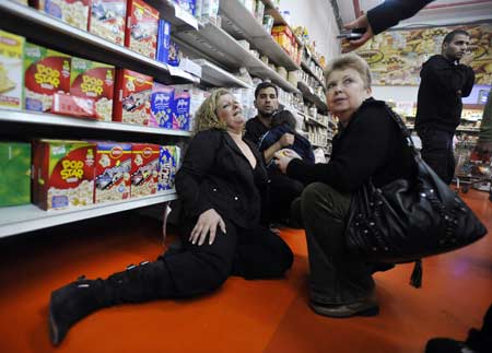 Israelis sit on the floor in a supermarket after a rocket fired by Palestinian militants in Gaza landed in the southern town of Sderot December 17, 2008. Palestinian militants in the Hamas-ruled Gaza Strip stepped up rocket attacks on southern Israel on Wednesday, wounding at least two people and raising tensions two days before a ceasefire was set to expire.