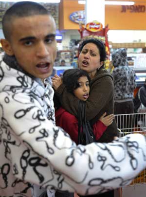 Israelis react after a rocket fired by Palestinian militants in Gaza landed in the southern town of Sderot Dec. 17, 2008. Palestinian militants in the Hamas-ruled Gaza Strip stepped up rocket attacks on southern Israel on Wednesday, wounding at least two people and raising tensions two days before a ceasefire was set to expire.