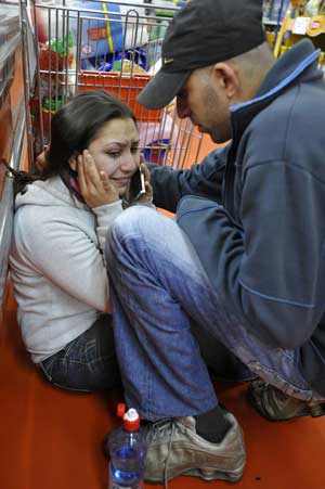 Israelis react after a rocket fired by Palestinian militants in Gaza landed in the southern town of Sderot Dec.17, 2008. Palestinian militants in the Hamas-ruled Gaza Strip stepped up rocket attacks on southern Israel on Wednesday, wounding at least two people and raising tensions two days before a ceasefire was set to expire. 