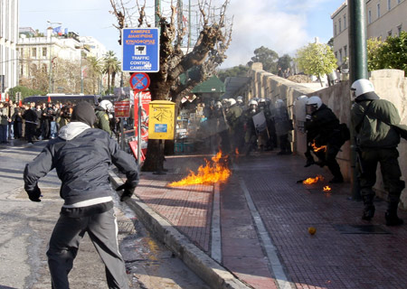  A young protestor hurls firebombs at riot police during a demonstration in Athens, capital of Greece, Dec. 18, 2008.