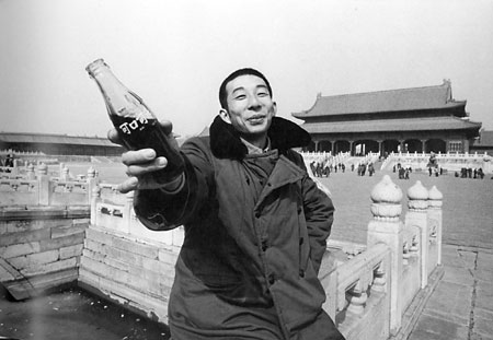 1981, a youth brandishes a bottle of Coca-Cola in the Forbidden City. Ever since Deng Xiaoping's reform and opening-up policy, China has been riding an economic boom, attracting huge investment from abroad. Coca-Cola, which was first sold in China in the 1920s, set up its first plant in Beijing in 1980. [China Daily]