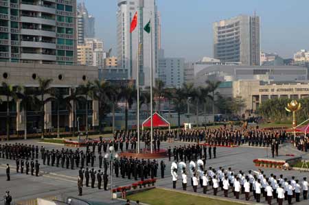 The government of Macao Special Administrative Region (SAR) holds a flag-raising ceremony of China's national flag (L) and the Macao SAR flag to mark the ninth anniversary of Macao's return to the motherland at the Golden Lotus Square in Macao, south China, Dec. 20, 2008. [Xinhua]