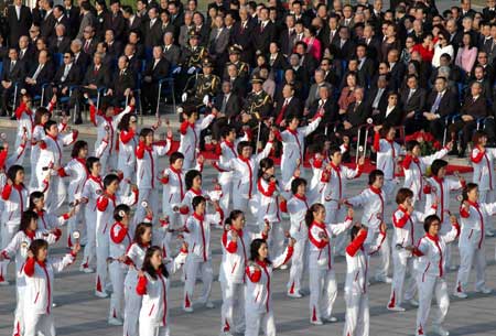 Local people perform dance during the flag-raising ceremony at the Golden Lotus Square in Macao, south China, Dec. 20, 2008.[Xinhua]