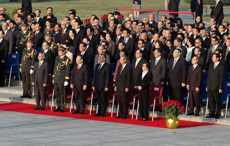  Macao Special Administrative Region (SAR) Chief Executive Edmund Ho Hau-wah (3rd R Front) attends the flag-raising ceremony at the Golden Lotus Square in Macao, south China, Dec. 20, 2008. 