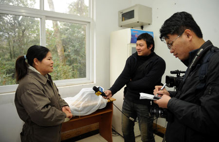 Taiwanese caretaker You Xueyin (L) is seen during an interview at a panda breeding base in Ya'an county, southwest China's Sichuan province, December 21, 2008. Since October 2008, You and other two caretakers from the Taipei Mucha zoo came to Ya'an in two groups, learning skills to take care of Tuan Tuan and Yuan Yuan, the two pandas donated and to be sent by the Chinese mainland to Taiwan. [Xinhua]