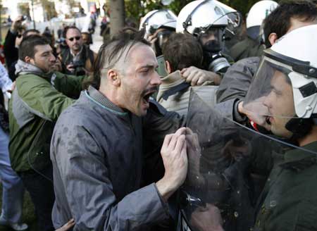 A protestor argues with a policeman during demonstrations in Athens Dec. 20, 2008. People protesting over the fatal shooting of a youth in central Athens two weeks ago, threw garbage at the Christmas tree at central Syntagma square.