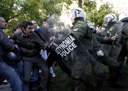 Protestors clash with police during demonstrations in Athens Dec. 20, 2008. People protesting over the fatal shooting of a youth in central Athens two weeks ago, threw garbage at the Christmas tree at central Syntagma square. 