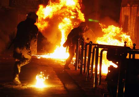 Riot police clash with demonstrators during riots outside the Athens Polytechnic Dec. 20, 2008. Greek demonstrators threw petrol bombs at finance ministry offices and torched two cars in central Athens on Saturday as anti-government protests entered a third week since police shot dead a teenager. 