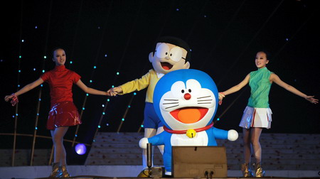 Performers dance with characters from the Doraemon cartoon series during the closing ceremony of the China-Japan Youth Friendly Exchange Year in Beijing, December 20, 2008. 