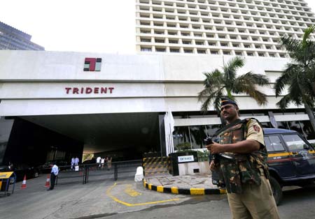 An armed policeman guards outside the Trident hotel of the Oberoi Group in Bombay, India, Dec. 21, 2008. The Oberoi Group owns Trident hotel and Oberoi hotel, which are located adjacent to each other and were attacked by terrorists last month. The Trident hotel resumed business Sunday after repairing for 20 days, however, the Oberoi hotel still needs to be repaired, due to serious damage.(