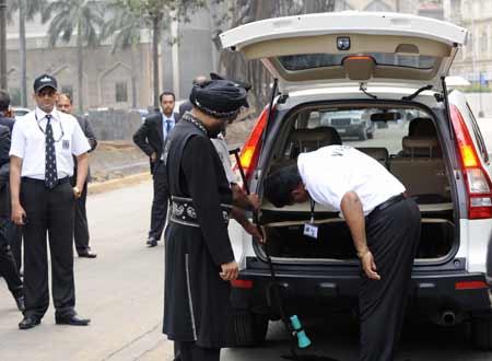 Security personnel check vehicles entering the reopening Taj Mahal hotel in Mumbai, India, on Dec. 21, 2008. The first batch of guests checked back into the Taj Mahal Place and Tower on Sunday after three weeks of refurbishment work.