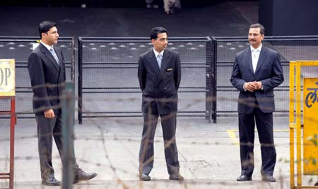 Security men stand outside the Trident hotel of the Oberoi Group in Bombay, India, Dec. 21, 2008. 