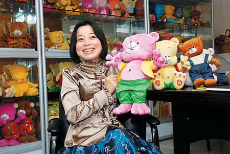 Hu Lantian, who owns the PP Bear Toy Company in the South China's Shenzhen, shows off the toys that would have been Christmas presents destined for European or American children, but because of the global economic slowdown, they will be sold on the domestic market. [China Daily]