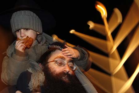 Members of Hungary's Jewish community gather to celebrate Hanukkah and to light the first candle on the menorah in downtown Budapest December 21, 2008. 