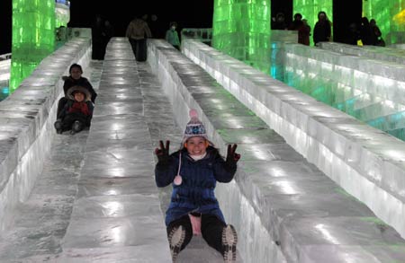 Visitors enjoy ice-made sliding board in the Ice and Snow World in Harbin, capital of northeast China's Heilongjiang Province, on Dec. 23, 2008. The annual ice and snow world in Harbin began a test run on Tuesday. [Xinhua] 