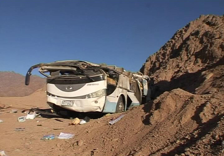 A video grab shows the wreckage of a bus sits by the side of the road after it overturned between two Egyptian resorts in the Sinai peninsula December 22, 2008.