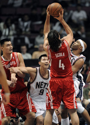 New Jersey Nets forward Yi Jianlian (@nd L) positions for a rebound in front of Houston Rockets center Yao Ming (L) as Rockets forward Luis Scola (2nd R) shoots over Nets guard Vince Carter in the first quarter of their NBA basketball game in East Rutherford, New Jersey December 22, 2008.