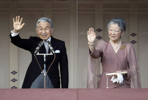 Japan's Emperor Akihito (L) and Empress Michiko wave to well-wishers through bullet-proof glass as he celebrates his 75th birthday at the Imperial Palace in Tokyo December 23, 2008. 