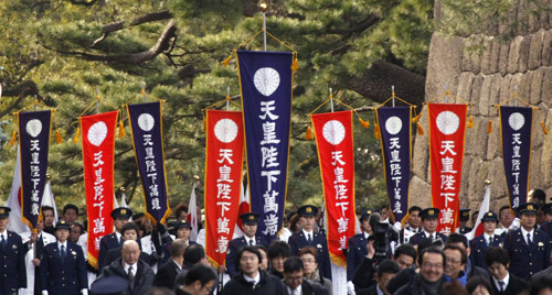 Well-wishers carry flags as they gather to celebrate Japan's Emperor Akihito's 75th birthday at the Imperial Palace in Tokyo December 23, 2008. 