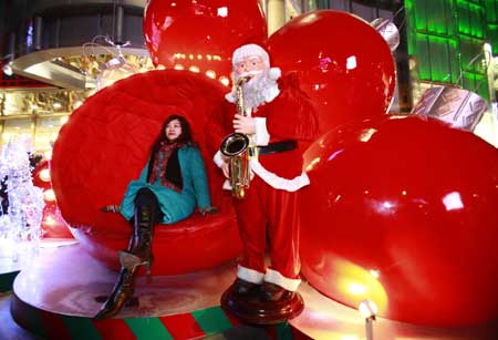 A Chinese girl sits with Santa Claus in downtown Beijing Dec. 24, 2008.