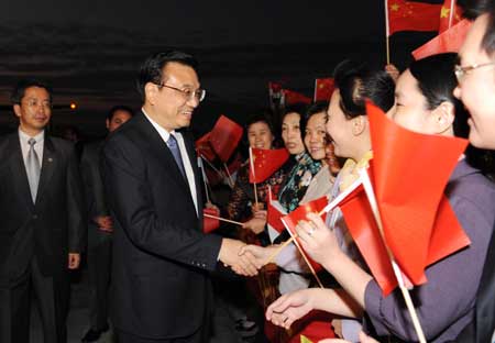 Visiting Chinese Vice-Premier Li Keqiang is greeted by Chinese people on his arrival at an airport in Cairo, capital of Egypt, Dec. 24, 2008.