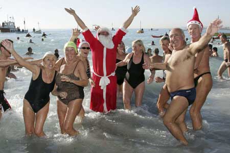 A man dressed as Santa Claus reacts with bathers during the 64th Christmas swim in Nice, southeastern France, Dec. 21, 2008.
