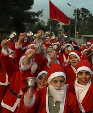 Students dressed as Santa Claus take part in a march, organised by Christian churches, to celebrate Christmas in Damascus Dec. 23, 2008.