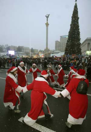 A group of volunteers dressed as Father Frost, equivalent to Santa Claus, dance in central square of Kiev Dec. 20, 2008.
